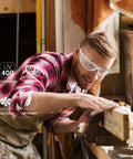 Man using Tough As Nails ANSI Z87.1 Certified Safety Glasses For Men scratch resistant polycarbonate lens in workshop.