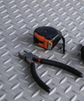 Tough As Nails Vinyl Diamond Plate Mat, tools on gray floor runner mat, heavy duty non slip surface, workshop setup.