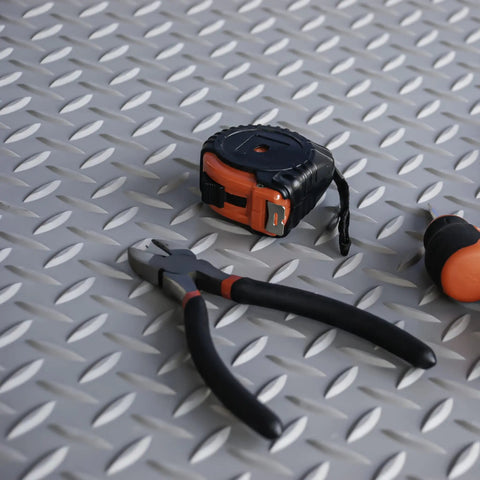 Tough As Nails Vinyl Diamond Plate Mat, tools on gray floor runner mat, heavy duty non slip surface, workshop setup.