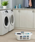 XL Hip Hugger Laundry Basket 2.1 Bushel White With Royal Blue Handles placed in modern laundry room near washing machines