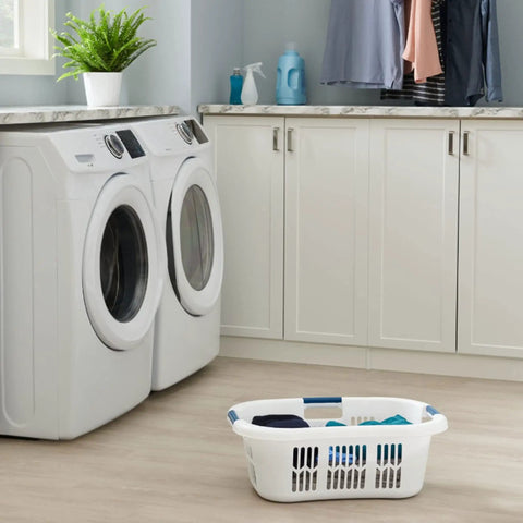 XL Hip Hugger Laundry Basket 2.1 Bushel White With Royal Blue Handles placed in modern laundry room near washing machines