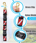 Scuba BC Fin Holder And Mask Clip with brass clip, red nylon webbing, and quick-release buckle on display with dive flag pattern.