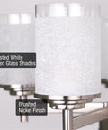 Close-up of frosted white linen glass shades and brushed nickel finish on modern farmhouse 19 inch 5 light chandelier fixture.