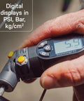 Hand holding Digital Tire Pressure Gauge With Dual Valve SmartHead For Presta And Schrader, clear LCD readout 5.4 PSI.