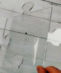 Transparent acrylic puzzle piece template from Four In One Acrylic Router Template Kit for woodworking projects.