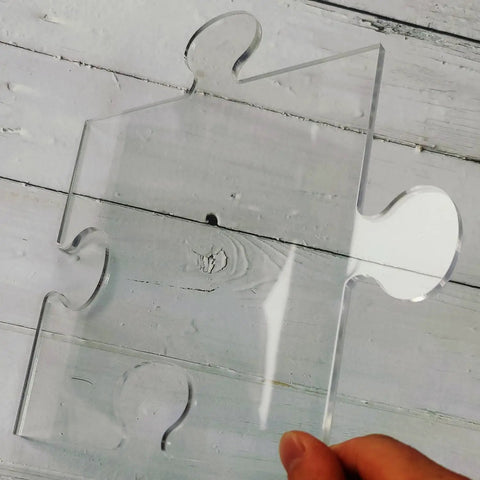 Transparent acrylic puzzle piece template from Four In One Acrylic Router Template Kit for woodworking projects.