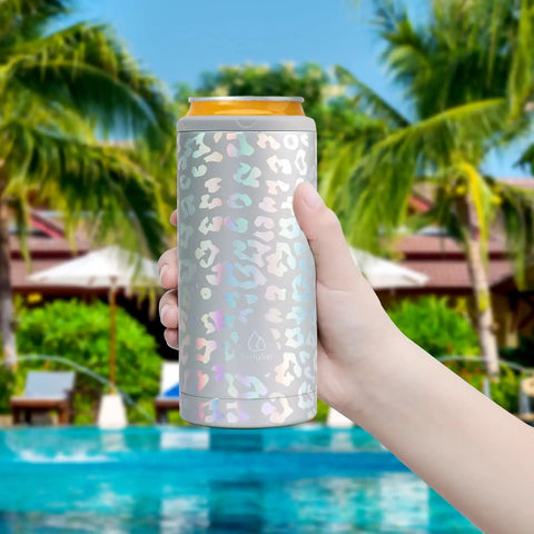 Laser Leopard Skinny Can Cooler Made With Double Wall Vacuum Insulated Stainless Steel To Keep Your Twelve Ounce Tall Boys Frosty All Night Long, held by a hand near a pool.