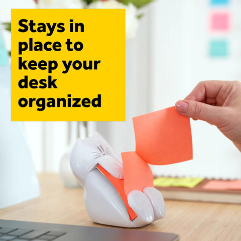 Hand pulling note from Cat Themed Pop Up Sticky Note Dispenser With 3x3 Pink Notes 45 Sheets Easy Refill Cute Desk Organizer For Home Office Or Classroom A Fun Way To Keep Notes Neat And Alerts On Point.