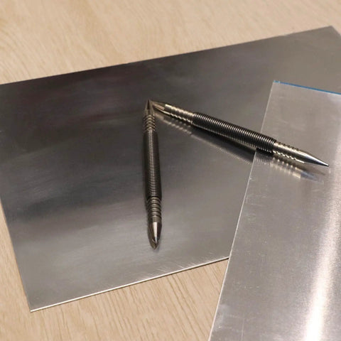 Dual Head Hammerless Nail Setter And 3/16 In Center Punch With 3500 PSI Striking Force on metal surface