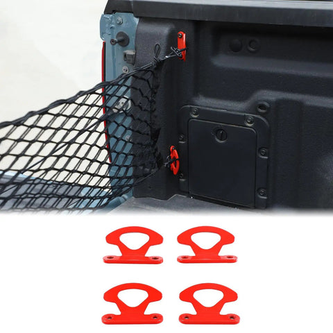 Rock Solid Carbon Steel Tie Down Hooks Four Pack For Ford Maverick 2022 To 2025, red cleat anchors with a net in truck bed.