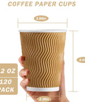 Person holding No Sleeve Needed 12 Oz Ripple Wall Corrugated Insulated Paper Cup with Anti Scald Grip for Hot or Cold Drinks Great for Office Cafe Party or Travel 120 Pack