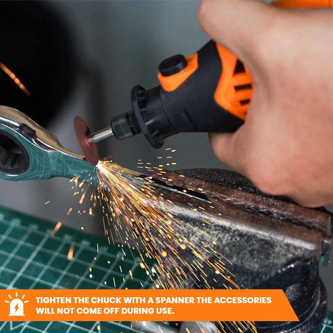 Close-up view of an orange and black rotary tool grinding metal, sparks flying from a cutting disc