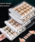Double Layer Egg Storage Container For Refrigerator With Drawer Style Stackable Egg Holder Clear Plastic Tray Holds 40 Eggs Easy Access Fridge Organizer Keeps Eggs Fresh And Safe From Crushed, showing open drawers filled with eggs.