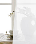Airy Sheer Door Curtain Panel 25 By 72 Inches White Linen Look Voile with Rod Pocket hung near window, dining setup visible
