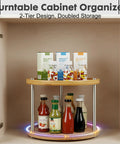 Two Tier Lazy Susan Organizer Revolving Turntable For Cabinets And Countertops 10 Inch Wood Spice Rack in a kitchen cabinet with bottles and jars.