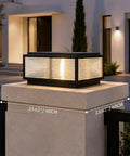 Level Up Your Curb Game With This Badass Outdoor Porch Lamp Post Light Featuring A Large Black Gate Column Pillar Design Built Tough For Weatherproof Pathway Vibes Classic Carriage Styling on a stone pedestal.