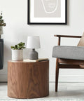 Gray Concrete Table Lamp With White Fabric Shade on wooden table in living room.