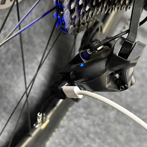 Close-up of bike gear mechanism with Type C Battery With Lanyard For 12 Speed E Bike Replacement Adapter attached.