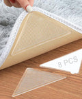 Triangle Anti Slip Rug Tape Pad Set Keeps Rugs In Place And Prevents Curling, Washable And Reusable Clear Rug Tape For Hardwood Floors, Removable, Non Residue, 8 Pack Floor Protector. Showing triangle pad under rug corner.
