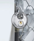 Stainless Steel Discus Padlock With Three Eighths Inch Hardened Shackle For Sheds, Garages, Fences And Storage Units installed on gate