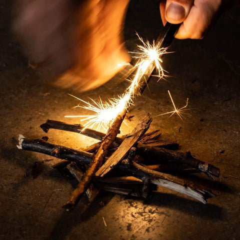 Ceramic Striker Ferro Rod Fire Starter Kit With Zirconia Stone in use, emitting sparks on sticks, emergency survival tool.