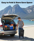 Man holding a folded Beefed Up Heavy Duty Foldable Wagon Cart With 300L Storage And 550 Lb Capacity near car on beach