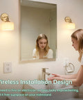 Woman using faucet under Vintage Battery Operated Wall Sconce With White Striped Glass Lampshade in bathroom.