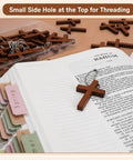 Hella Sturdy Wooden Cross Charms Bulk Pack Of Sixty Pocket Size Beads With Pre Drilled Hole For DIY Necklace Projects And Religious Craft Supplies Top Shelf Quality on open book.