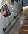 Rock Solid Adjustable Stair Handrail Featuring Smooth Round Pipe Grip And Heavy Duty Galvanized Steel Construction For Hella Secure Wall Mounted Support Indoors Or Outdoors, showing installation on a stairway.