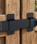 Built Tough As Nails Adjustable Slide Gate Latch 2 Pack Rugged Steel Fence Door Lock on wooden gate close-up.