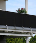 Black Balcony Privacy Screen Windscreen Shade Netting 3x10 Feet With Grommets UV Protection 95 Percent installed on a balcony