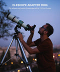 Man using a telescope with 1.25 Inch to 0.965 Inch Eyepiece Adapter for 24.5mm to 31.7mm Telescopes, cityscape background