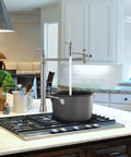 Pot Filler Deck Mount Kitchen Faucet In Brushed Nickel, Folding 2-Handle Design over stove filling black pot.