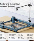 Front view of Longer camera kit for laser engravers mounted on a blue metal gantry with an adjustable vertical arm and camera over the engraving bed.