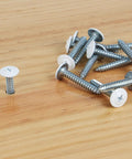 Heavy Duty White Truss Head Wood Screws 120 Piece Pack With Phillips Drive And Included Screwdriver Tool on wooden surface
