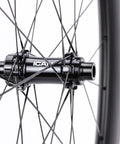 Close-up of G27 700C Carbon Gravel Wheelset With 50mm Aero Rim And 27mm Inner Width hub and spokes, tubeless clincher