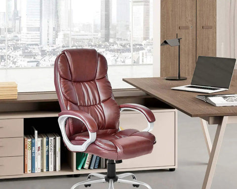 Ergonomic High Back Office Chair With PU Leather Adjustable Desk Chair Swivel Task Chair in brown by a modern office desk