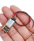 Close-up of a single Six-Pack Mini N20 Gear Motor, 3V To 6V DC High Torque Micro Motor with metal gearbox in a hand.