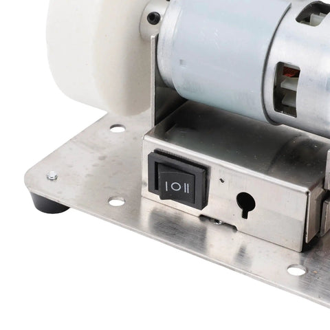 Super Compact Mini Bench Grinder With Two Polishing Wheels And Seven Speed Settings overall view of motor switch on stainless steel base.