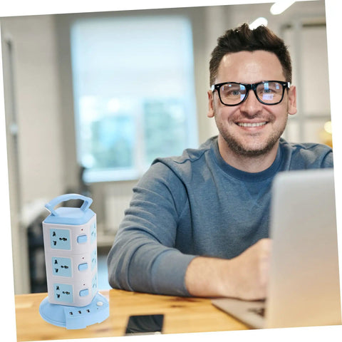 Heavy Duty USB Power Strip With Plenty Of Outlets And Superfast Ports on a desk, charging devices while a man works.