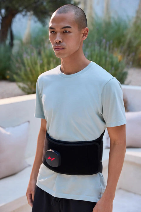 Person wearing Venom 2 Back Wrap With Next Level Heat And Vibration For Fast Pain Relief Soreness And Inflammation outdoors