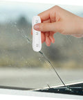 Person using DIY Friendly Windshield Crack Repair Kit With Curing Light on car glass to fix crack and restore clarity.