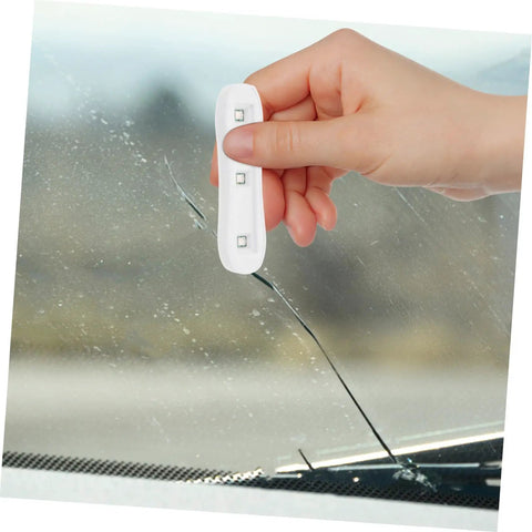 Person using DIY Friendly Windshield Crack Repair Kit With Curing Light on car glass to fix crack and restore clarity.
