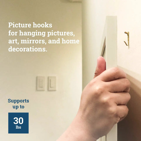 Heavy Duty Picture Hangers For Drywall And Plaster 30 Pound Capacity 25 Pack in use holding a picture frame securely