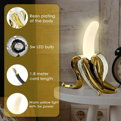 Banana Shaped Table Lamp With LED Night Light Modern Resin Banana Lighting Fixture on table, warm glow, resin plating, LED bulb shown.