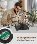 Person using Two In One Magnetic Soldering Third Hand With Heavy Duty Metal Workbench Vise PCB Circuit Board Holder; detail of magnifier lens.