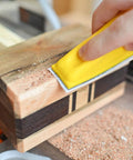 Using MicroZip Sander Kit with Assorted Grit Sanding Sheets for 3.5 Inch by 1 Inch Hook and Loop Pad on wooden surface.