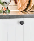 White cabinet with 10 Pack Matte Black Cabinet Knobs, 1.2 Inch Round Drawer Knobs For Kitchen Cabinets, Easy Install.