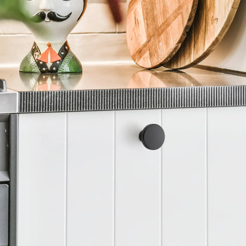 White cabinet with 10 Pack Matte Black Cabinet Knobs, 1.2 Inch Round Drawer Knobs For Kitchen Cabinets, Easy Install.