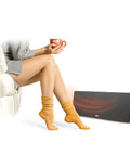 New And Improved Flat Panel Space Heater For Home And Office Portable 150W Heater With Built In Thermostat next to seated woman